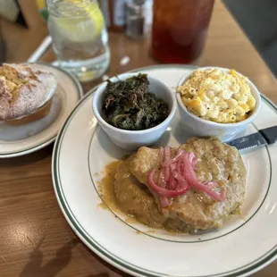 Smothered pork chops, collard greens, Mac and cheese and cornbread