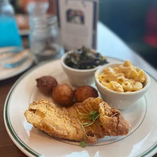 catfish with sides of greens, mac and cheese and hush puppies