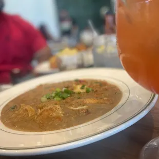 a bowl of soup and a glass of orange juice