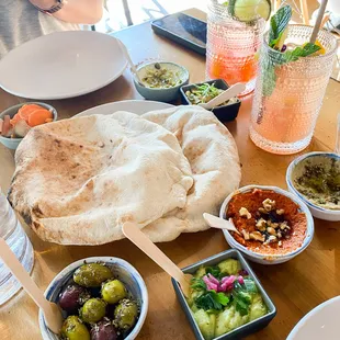 salatim: 2x fresh baked pita + mix and match spreads: feta &amp; pistach, baba ganoush, favs dip, muhamarra (pepper spread), olives, fennel slaw