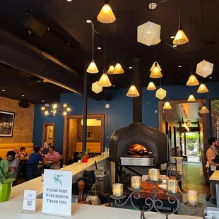 a restaurant with a wood burning oven