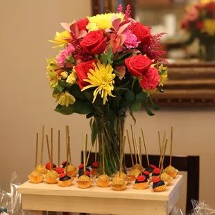 a vase of flowers and mini appetizers