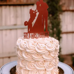 a wedding cake with a silhouette of a bride and groom