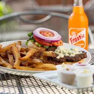 a plate of fries and a bottle of soda