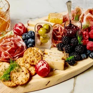 a platter of fruit, cheese, crackers, and crackers