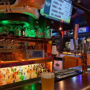 a glass of beer on a bar