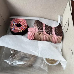 a cupcake and donut in a box