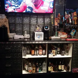 a man in a cowboy hat behind a bar