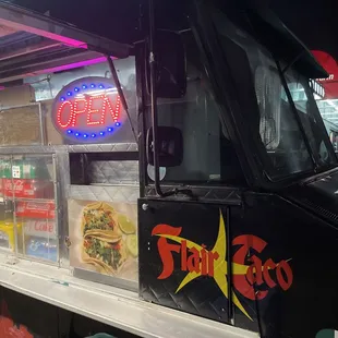 a food truck with neon signs