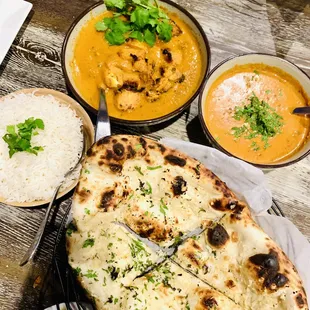 a plate of food and bowls of soup