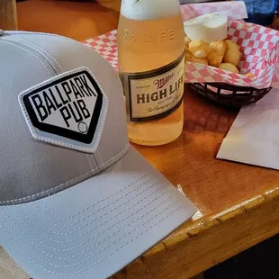 a man sitting at a table with a bottle of beer