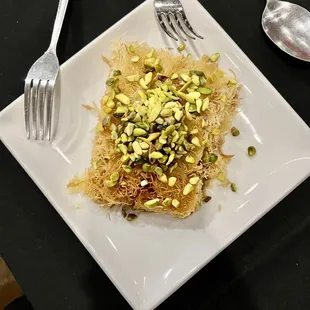 a plate of food with a fork and spoon