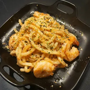 a black plate of food on a table