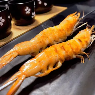 two cooked shrimp on a grill