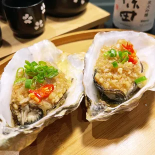 two oysters on a wooden plate