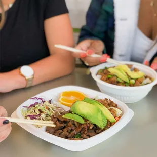 a plate of food with chopsticks