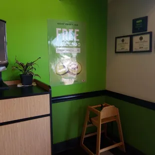 a green wall and a television