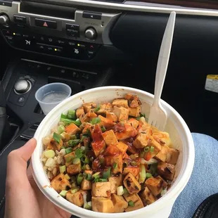  a person holding a bowl of food