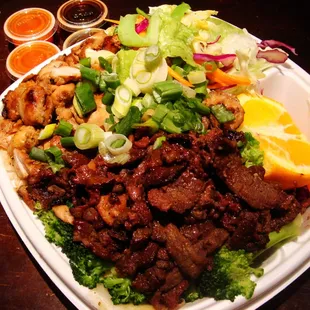 Works Plate with brown rice and green onions and Magic Sauce and Hot Sauce!