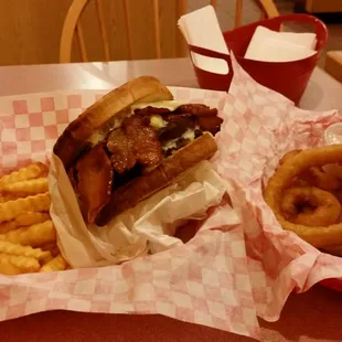 Sourdough 1/2 lb bacon burger with fries and a small onion ring.