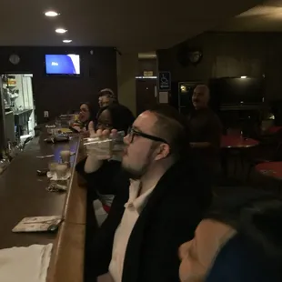 a group of people sitting at a bar