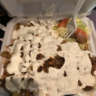 Chicken and lamb over rice with extra sauce.