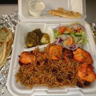 Qabuli Palaw with side potato qorma and salad. Some extra pita bread and corn on the cob.