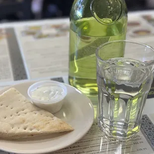 Warm water with complimentary bland tzatziki sauce and pita bread