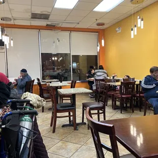 people sitting at tables in a restaurant