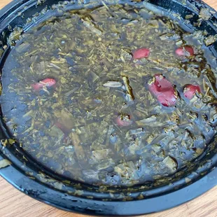 a hot pot of soup on a wooden table