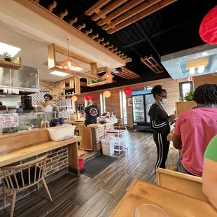 a woman sitting at a table in a restaurant