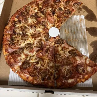 a half eaten pizza in a box