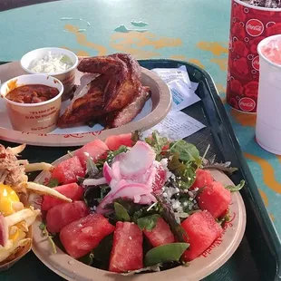 Rib/chicken combo, watermelon salad, and pulled pork cheese fries.