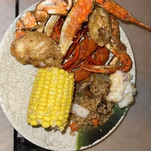crab legs, corn, and mashed potatoes