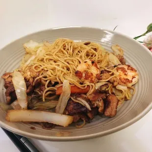 a bowl of noodles with meat and vegetables