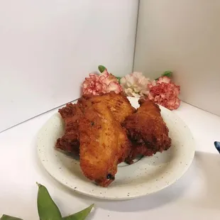 two pieces of fried chicken on a plate