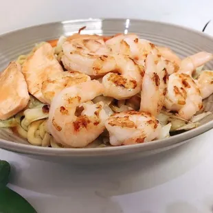 a bowl of shrimp and noodles