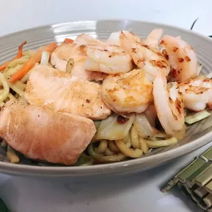 a plate of shrimp and noodles