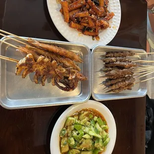 Beef skewers, cucumber salad, and eggplant in garlic sauce