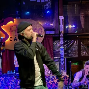 a man on stage singing into a microphone