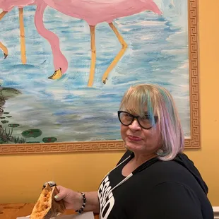 a woman eating a slice of pizza