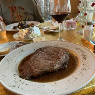 a large piece of steak on a white plate