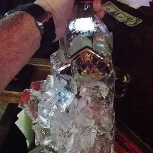 a person pouring a bottle of alcohol