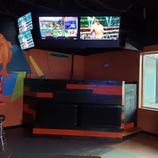 a bar with two televisions
