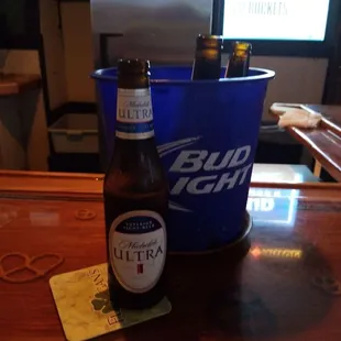 a bottle of bud light next to a cooler