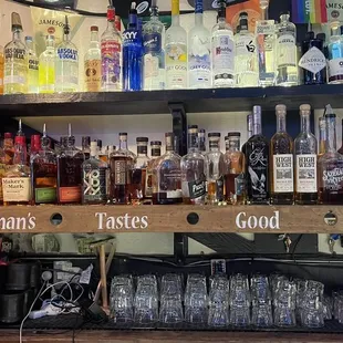 a shelf full of liquor bottles