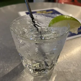 a glass of ice and a lime slice