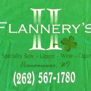 a green t - shirt with a shamrock