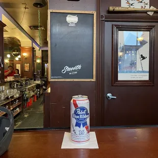 a can of beer on the bar