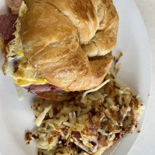 Ham, cheese and egg croissant and hash browns